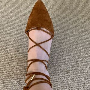 Tie up caramel flats with a pointy toe.